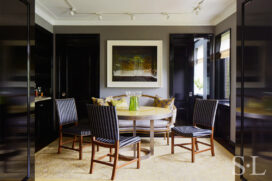 Fifth Avenue Pied-à-Terre dining room with artwork by Abelardo Morell and a round dining table with high gloss yellow lacquered wood top