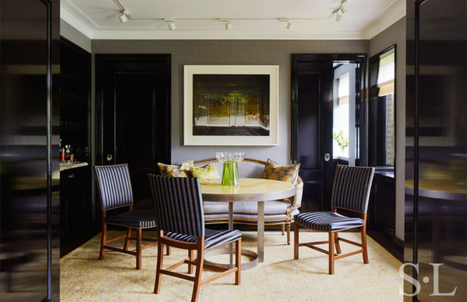 Fifth Avenue Pied-à-Terre dining room with artwork by Abelardo Morell and a round dining table with high gloss yellow lacquered wood top