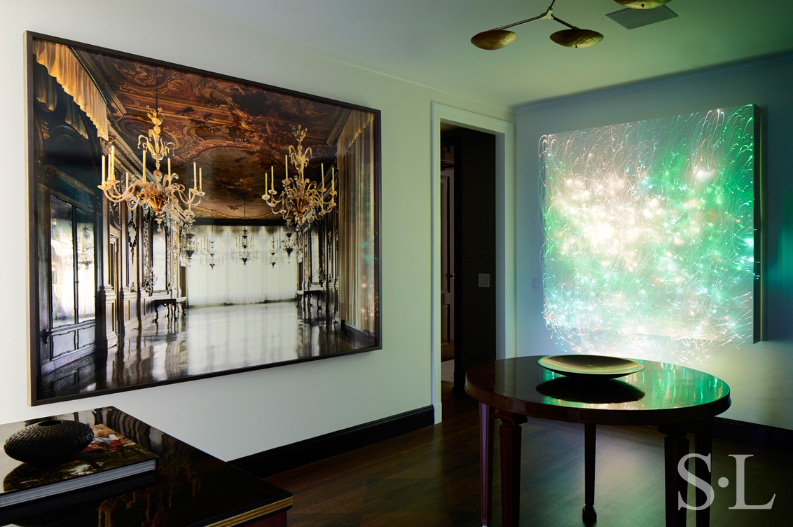 Fifth Avenue Pied-à-Terre foyer featuring photograph by Michael Eastman and a luminous wall sculpture by Astrid Krogh and brass chandelier by Lindsey Adelman