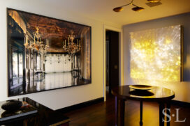 Fifth Avenue Pied-à-Terre foyer featuring photograph by Michael Eastman and a luminous wall sculpture by Astrid Krogh and brass chandelier by Lindsey Adelman