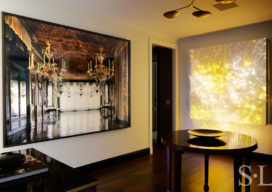 Fifth Avenue Pied-à-Terre foyer featuring photograph by Michael Eastman and a luminous wall sculpture by Astrid Krogh and brass chandelier by Lindsey Adelman