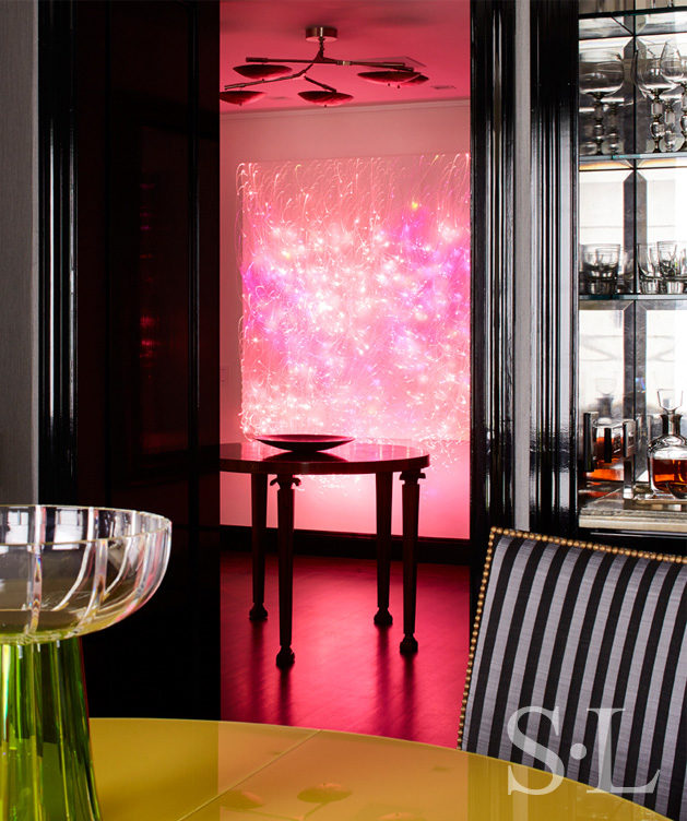 Fifth Avenue Pied-à-Terre view from dining table to foyer showing luminous wall sculpture by Astrid Krogh in hot pink