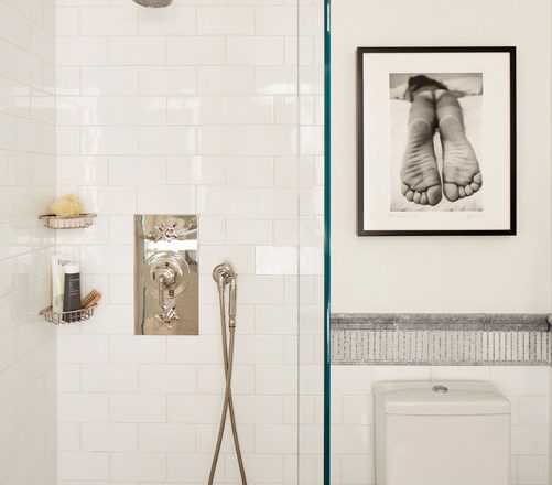 White and grey bathroom, view into shower with nickel hardware, and black and white photography