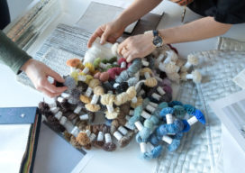Member's of Suzanne Lovell Inc.'s design team work on the design of a custom rug