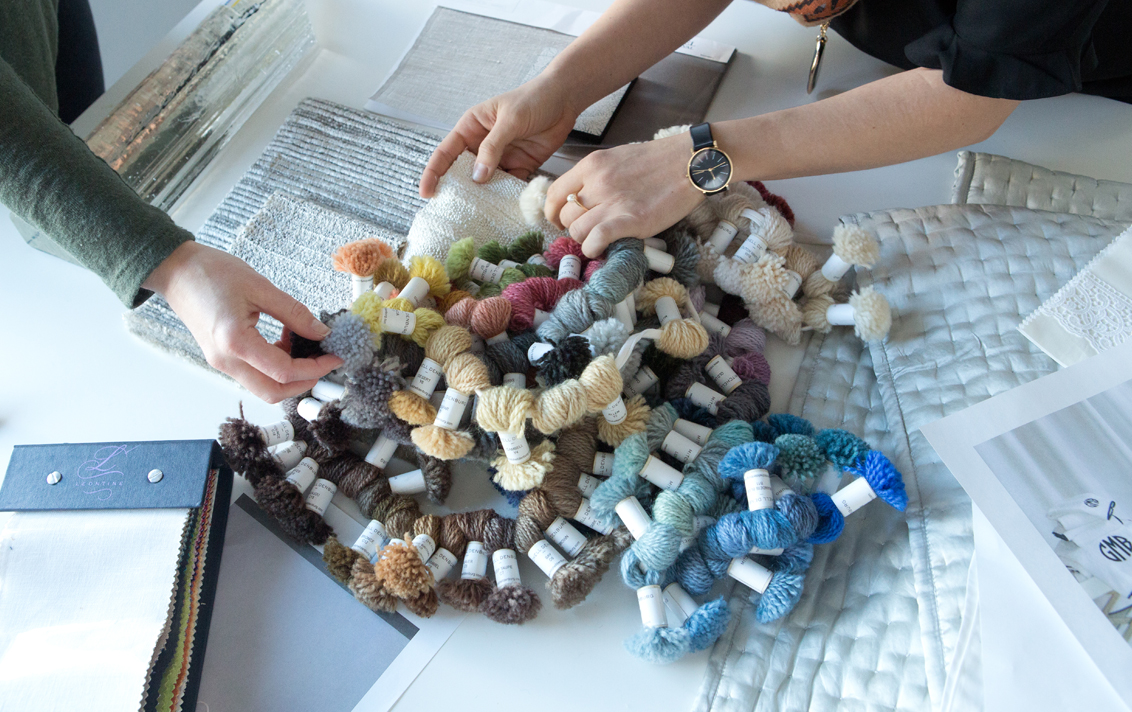 Member's of Suzanne Lovell Inc.'s design team work on the design of a custom rug