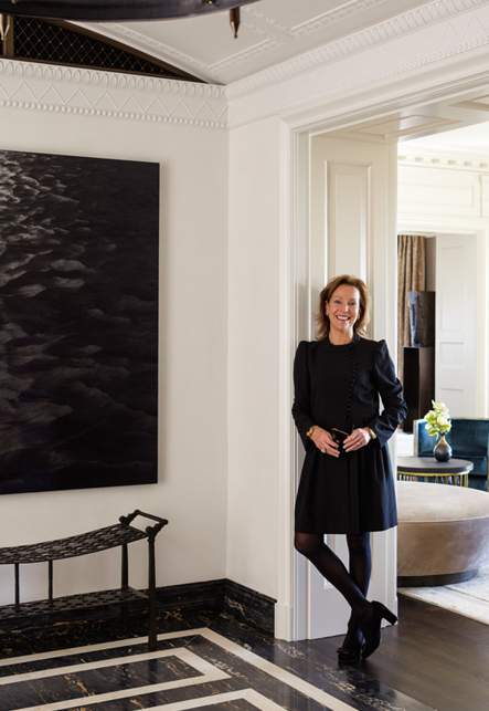 Suzanne Lovell in the gallery of a residence she designed in Chicago with artwork by Karen Gunderson and bench by Ingrid Donat