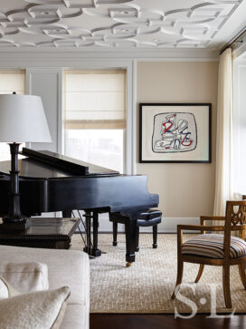 Detail of Chicago penthouse living room in a neutral palette with a piano and artwork by Jean Dubuffet