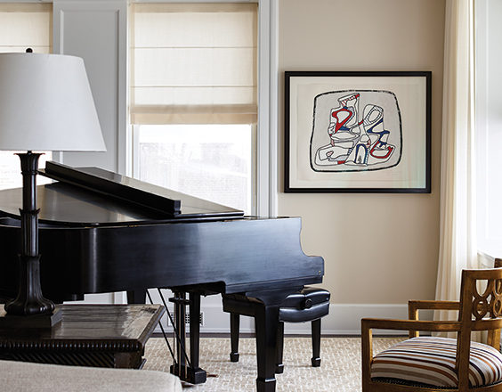 Detail of Chicago penthouse living room in a neutral palette with a piano and artwork by Jean Dubuffet