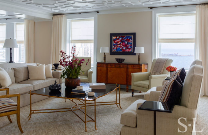 Chicago penthouse living room in a neutral palette with high-gloss plaster ceiling and artwork by Jean Dubuffet