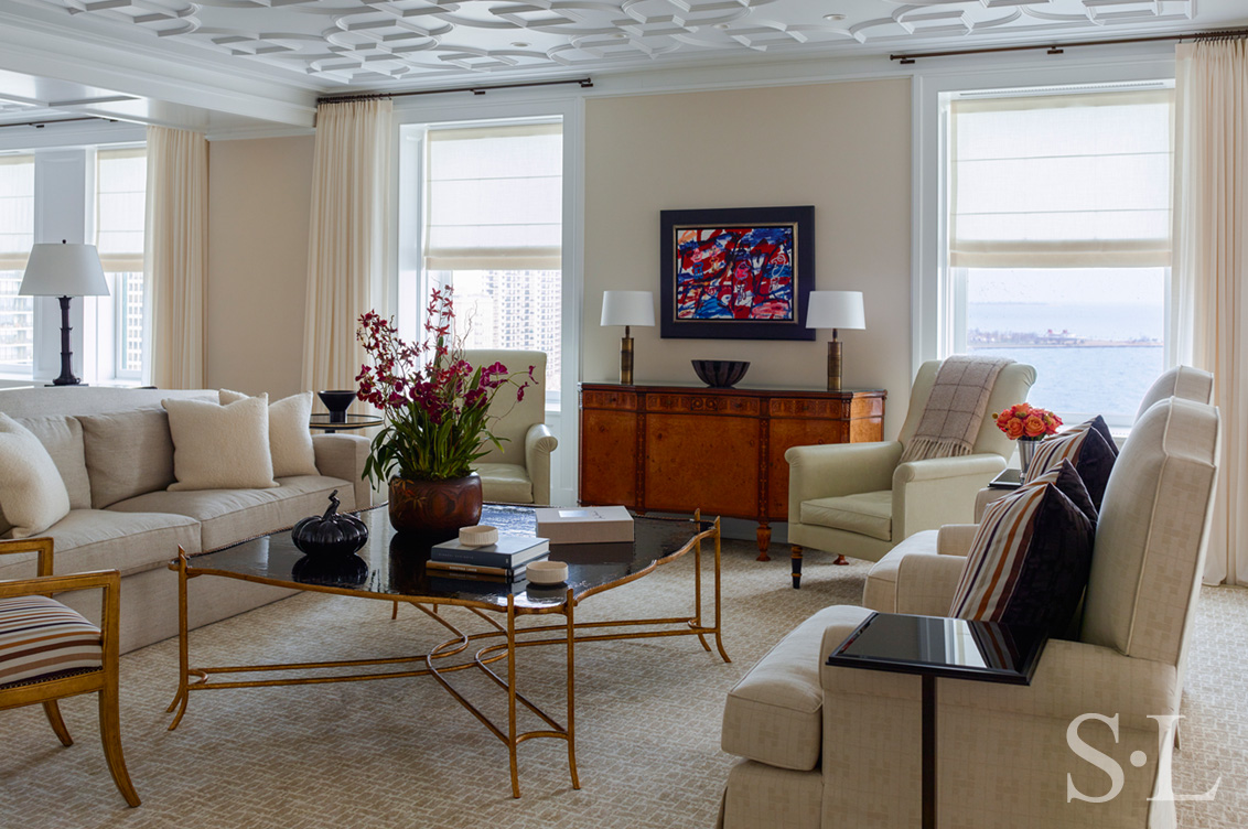 Chicago penthouse living room in a neutral palette with high-gloss plaster ceiling and artwork by Jean Dubuffet