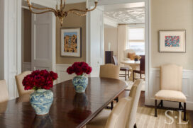 Chicago penthouse dining room and view into living room, featuring a mahogany table and Chippendale chairs