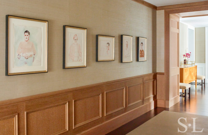 Chicago penthouse hallway with cerused oak paneled millwork and a collection of original artwork by David Hockney