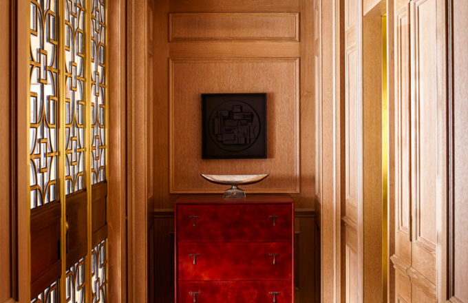 Chicago penthouse entry with limestone slab flooring, a cabinet made of leather and American black walnut, and artwork by Louise Nevelson