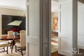 Chicago penthouse view into dining room through two large portals, with artwork by David Klamen