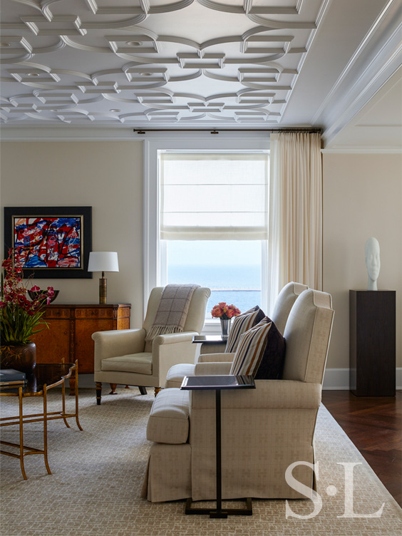 Detail of Chicago penthouse living room in a neutral palette with high-gloss plaster ceiling and view of Lake Michigan