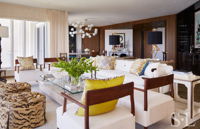 Light and bright great room interior designed with decorative pillows by Hermès and sofa by Robert Crowder