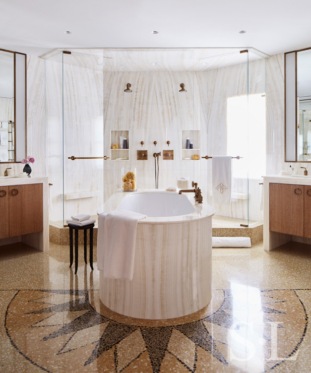 Master bath featuring onyx, cerused oak vanities and marble soaking tub