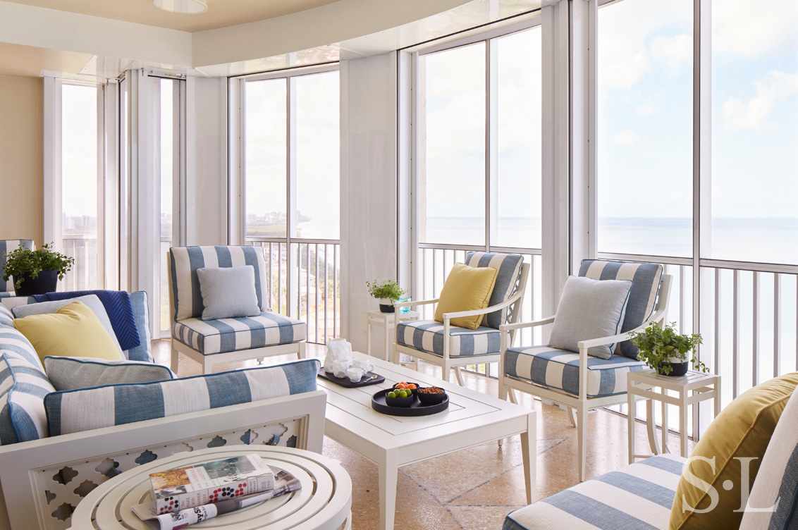 Terrace with Gulf Coast views and furniture by McKinnon and Harris upholstered in striped outdoor fabric by Perennials