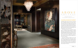 Interiors Magazine spread featuring Chicago skyline penthouse spacious entry gallery with cashew lacquered plaster walls and artwork by Manolo Valdés