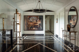 Large and welcoming entry gallery luxury interior renovation featuring artwork by Andrew Moore and Sidney Gordin