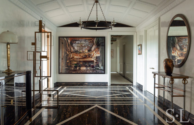 Large and welcoming entry gallery luxury interior renovation featuring artwork by Andrew Moore and Sidney Gordin