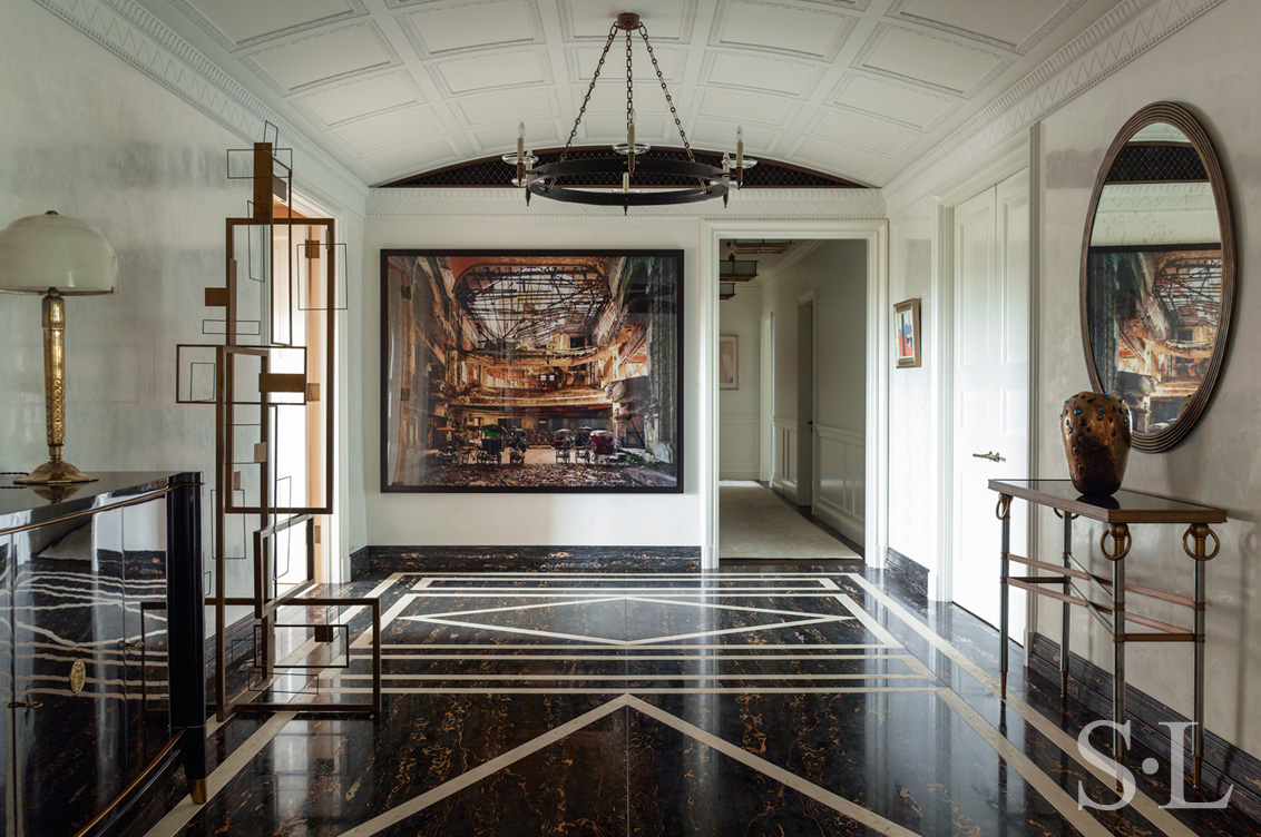 Large and welcoming entry gallery luxury interior renovation featuring artwork by Andrew Moore and Sidney Gordin