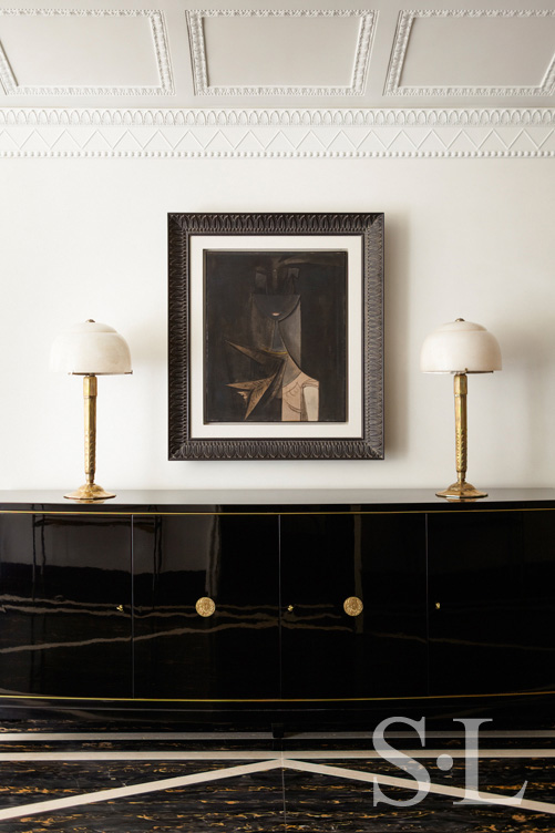 Entry gallery detail featuring artwork by Wilfredo Lam and a black lacquer De Coene Frères sideboard
