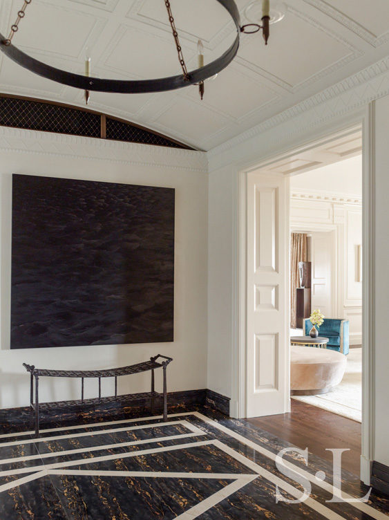 Entry gallery luxury interior renovation featuring artwork by Karen Gunderson and a bench by Ingrid Donat