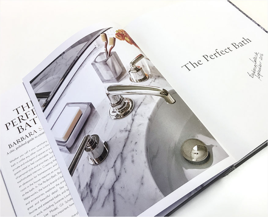 Front of book spread featuring a detail of a bathroom sink with hardware and accessories by Waterworks