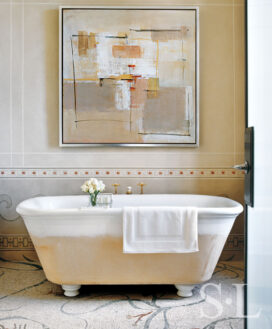 Deco-era duplex apartment bathroom with mosaic-covered floor and decorative wall painting and soaking tub