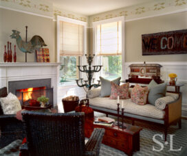 Restored landmark residence on former military base living room with fireplace, a rooster weather vane and sculptural plan stand