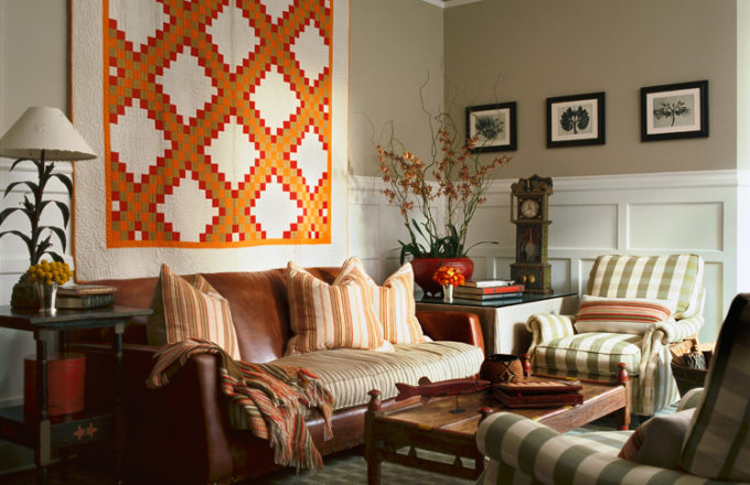 Restored landmark residence on former military base library seating area with a colorful Double Irish Chain quilt and photographs by Karl Blossfeldt