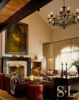 Living room of former artillery shed converted into luxury residence with 27-foot-high ceiling and arched windows