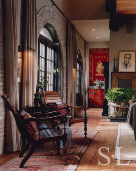 Former artillery shed converted into luxury residence hallway detail showing arched window surrounded by brick