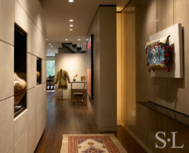 Lincoln Park Chicago landmark residence view from front door into foyer with display cabinet made of goatskin panels and collection of Native American objects and artifacts