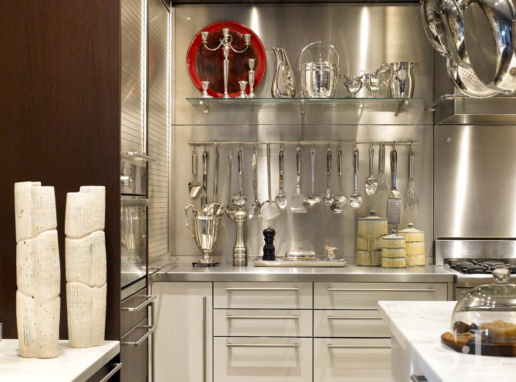 Chicago townhome kitchen detail showing stainless steel wall with hanging utensils