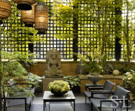 Chicago townhome terrace with trellising, a pergola and Asian lanterns