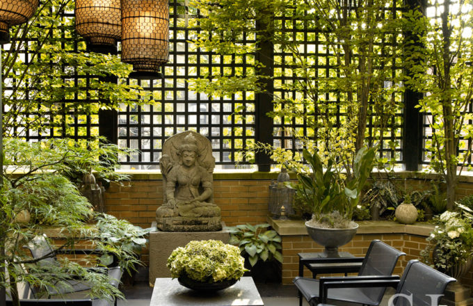 Chicago townhome terrace with trellising, a pergola and Asian lanterns