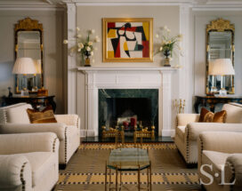 1920s era penthouse living room view of fireplace in soft black and white palette renovated by Suzanne Lovell Inc.