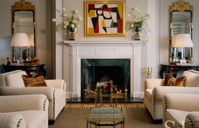 1920s era penthouse living room view of fireplace in soft black and white palette renovated by Suzanne Lovell Inc.