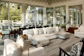 Great room view towards sectional sofa and dining table, the pool beyond