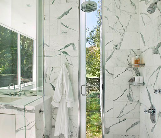 Lake House bathroom shower in marble that opens to outdoors