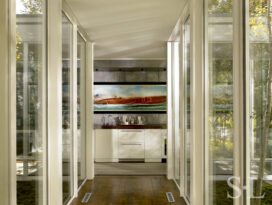 Hallway view towards wet bar with zinc covered walls