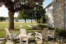 Outdoor seating area on side of home with view to the lake