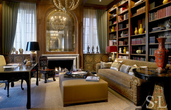 Library in Chicago Lincoln Park residence designed with walnut beams, fireplace and Tibetan chests