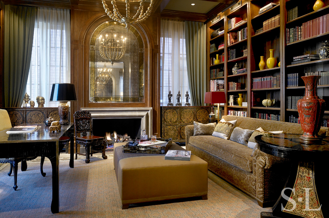 Library in Chicago Lincoln Park residence designed with walnut beams, fireplace and Tibetan chests