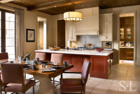 Kitchen with a Chinese-red lacquered island in Chicago residence designed by Suzanne Lovell Inc.