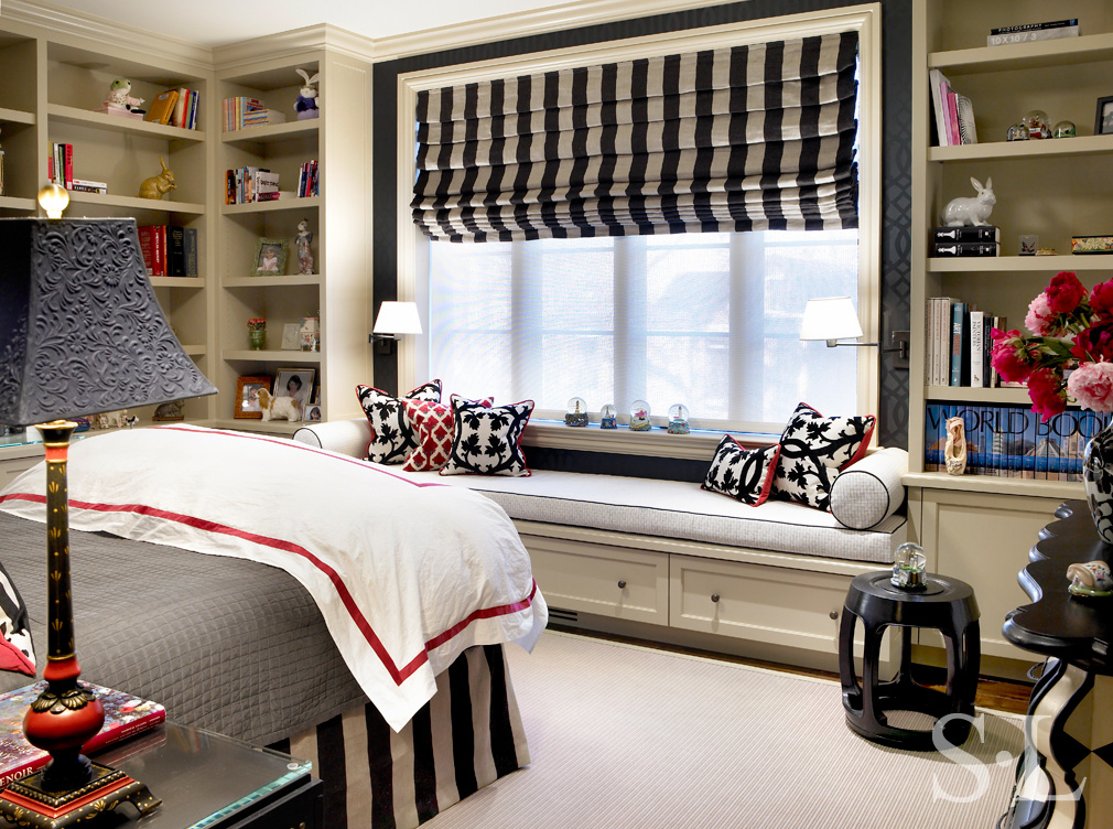 Girl's bedroom with black and white striped window coverings