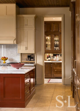 Kitchen and view to prep kitchen with a Chinese-red lacquered island