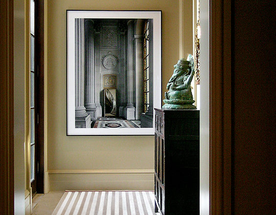 Hallway with striped rug and artwork by Robert Polidori